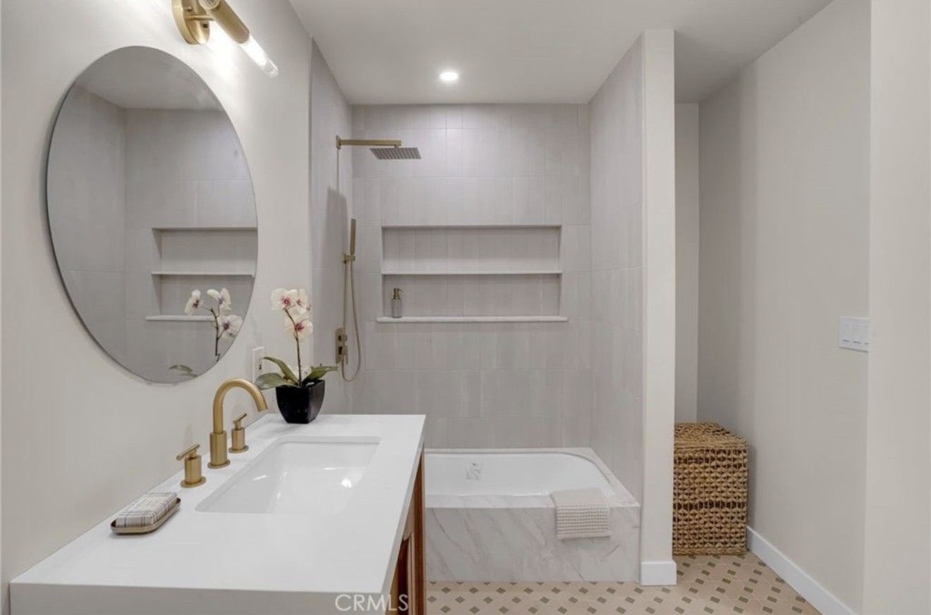 Updated bathroom with soaking tub and stone vanity