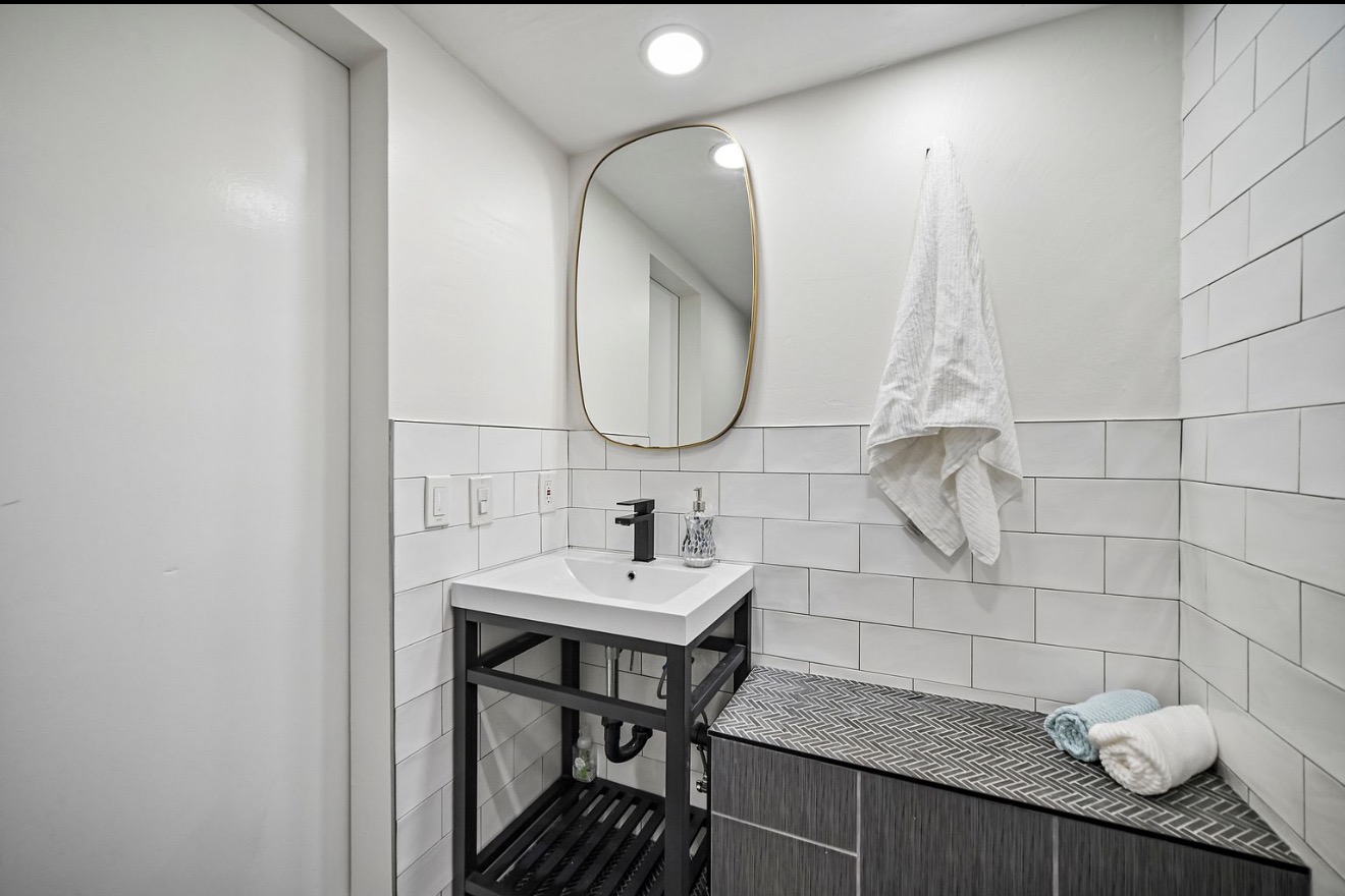 Updated bathroom with tiled bench and modern vanity