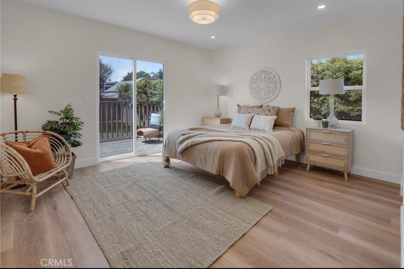 Primary bedroom opening to the rear deck
